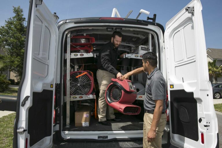 Storm damage restoration team unloading emergency drying equipment for residential property cleanup | Paul Davis Restoration of Northwest Virginia